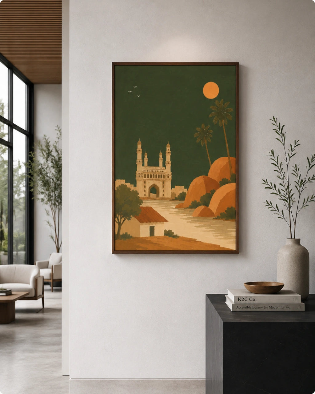 A framed art print featuring a stylized illustration of the Charminar in Cairo under a full moon, displayed on a light gray wall in a modern living room setting.