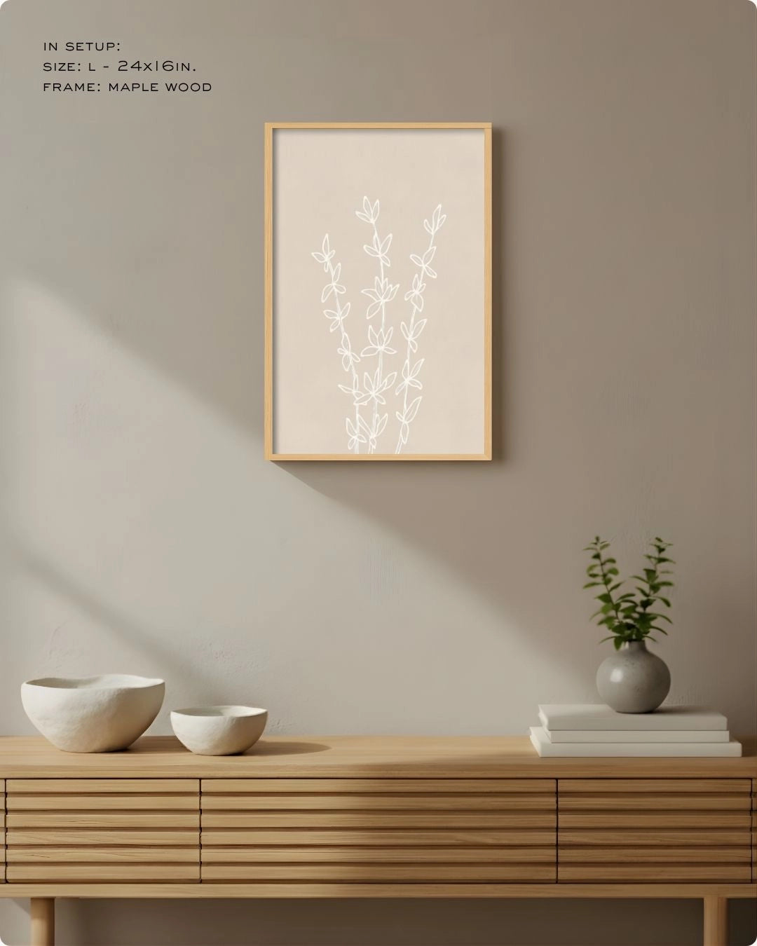 Small (Size S) Essence botanical accent print by K2C Co. in a Maple Wood frame, demonstrating small-space styling on a warm neutral wall above a slatted sideboard.