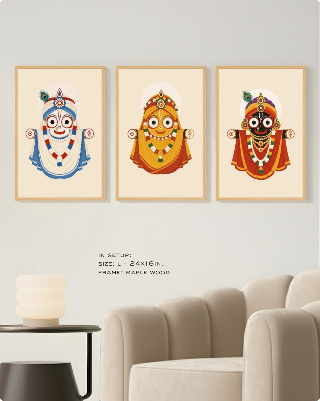 Visual size guide mockup for the Jagannath Triad 3 piece wall art set in Large size with satin gold frames displayed above a modern ribbed beige armchair.