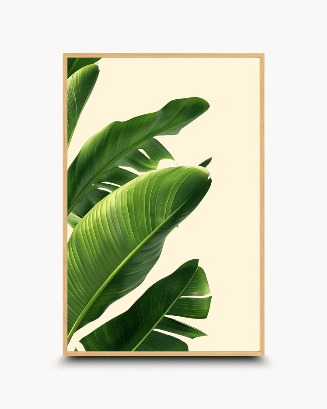 Minimalist tropical green leaf artwork by K2C Co. in a natural Maple Wood frame. High-quality botanical canvas print featuring banana leaves, bringing a touch of nature to minimalist home decor.