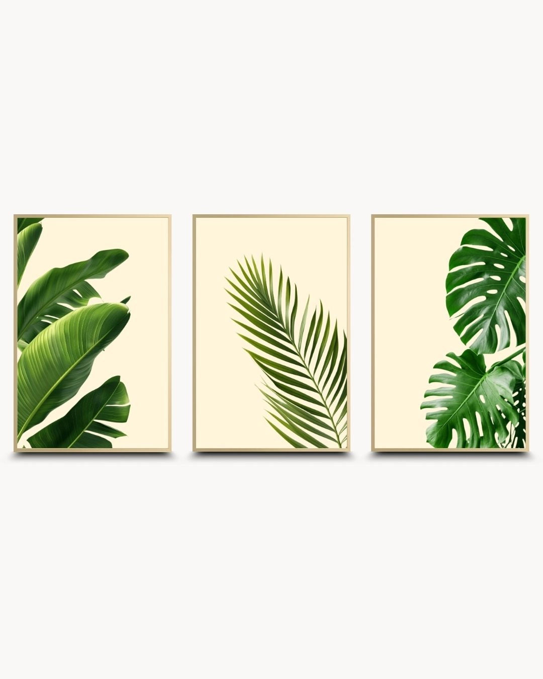 K2C Co. 3-piece tropical botanical leaf gallery wall set in elegant Satin Gold frames. High-contrast green leaves on a cream background for a luxury modern wall decor statement.