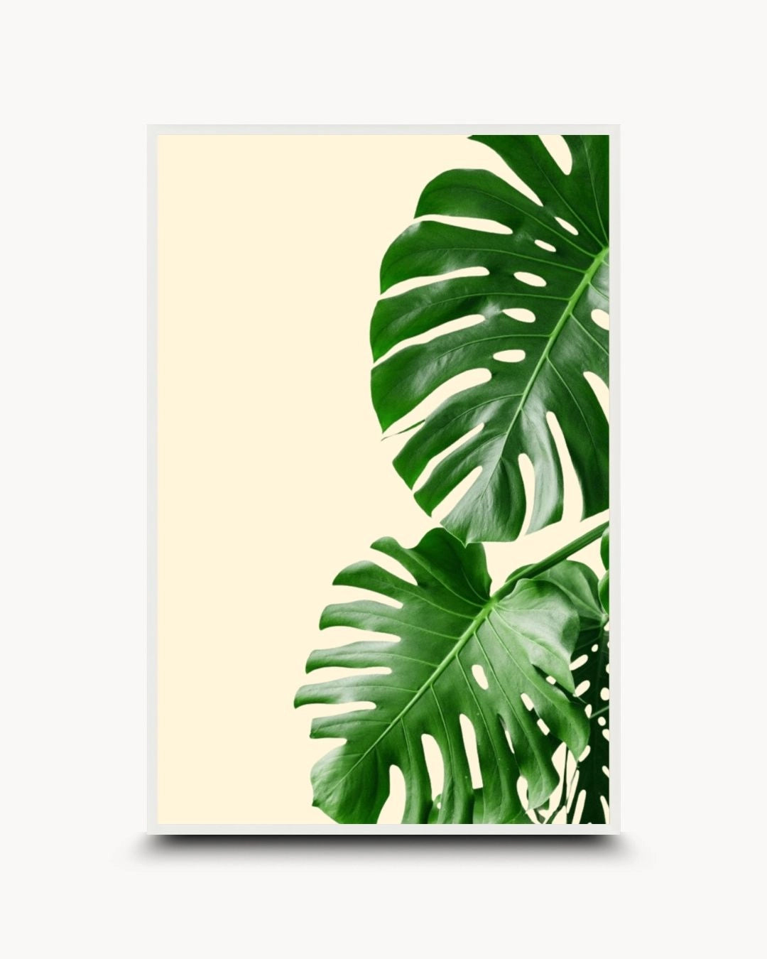 K2C Co. tropical Monstera leaf artwork in a Moon White frame. A clean, minimalist botanical print on a neutral background, perfect for a bright Japandi-style bedroom or modern office.