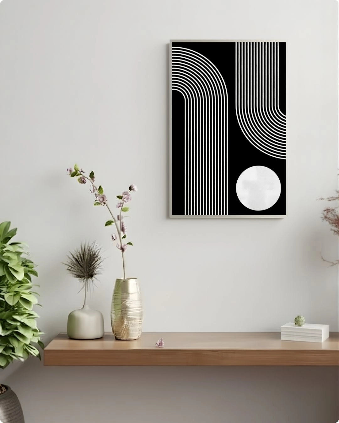 Abstract black and white wall art above a wooden shelf with decorative items.