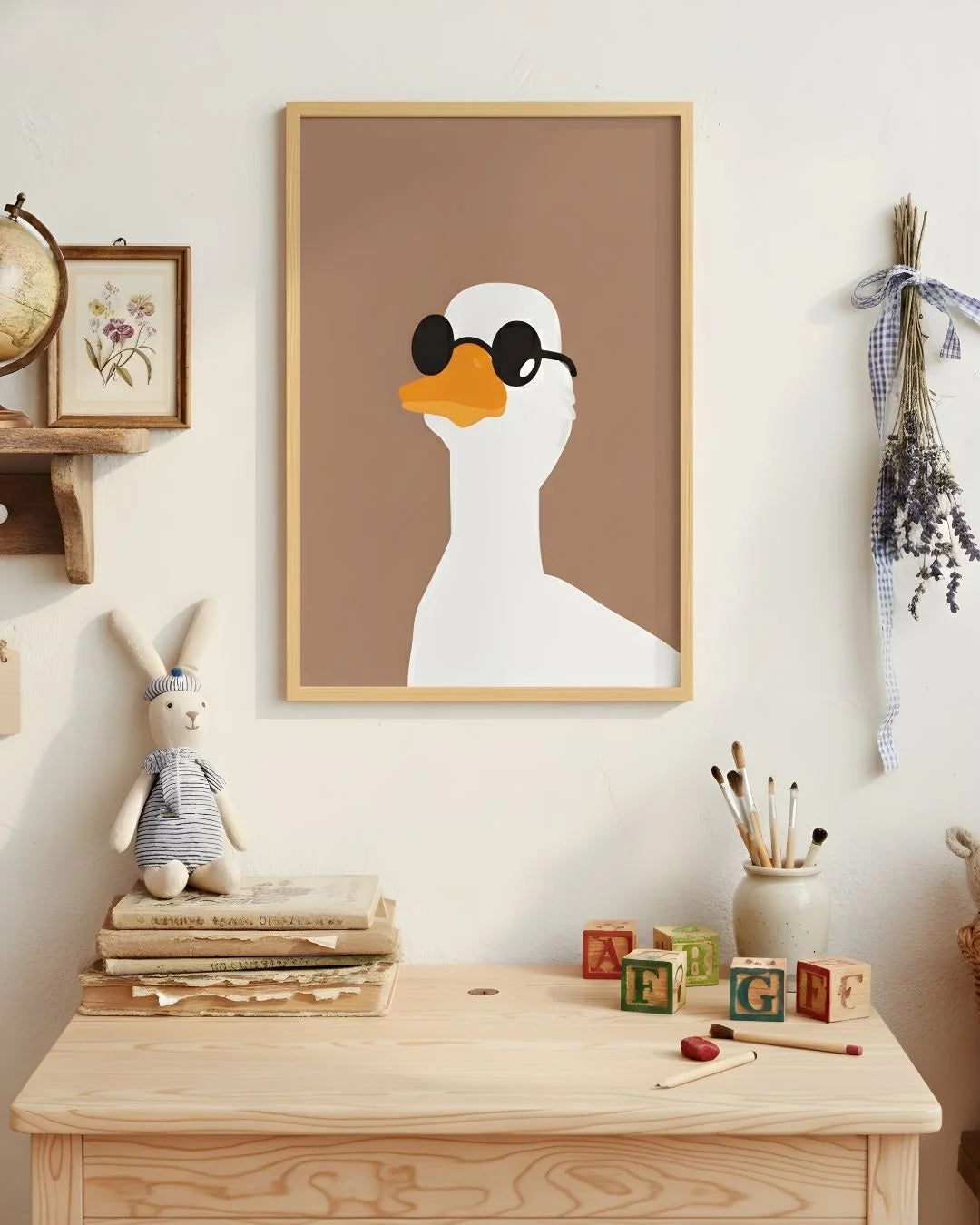 Playful duck with round sunglasses print in a 0.5-inch Maple Wood frame, styled in a light-filled nursery with wooden toys and a bunny plush.