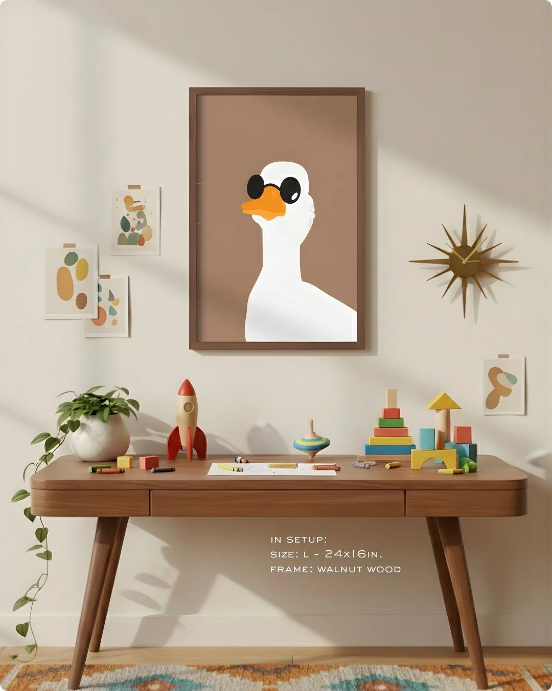 Large (Size L - 24x16in) duck with sunglasses art in a Walnut Wood frame, demonstrating scale above a modern wood desk with a retro starburst clock.