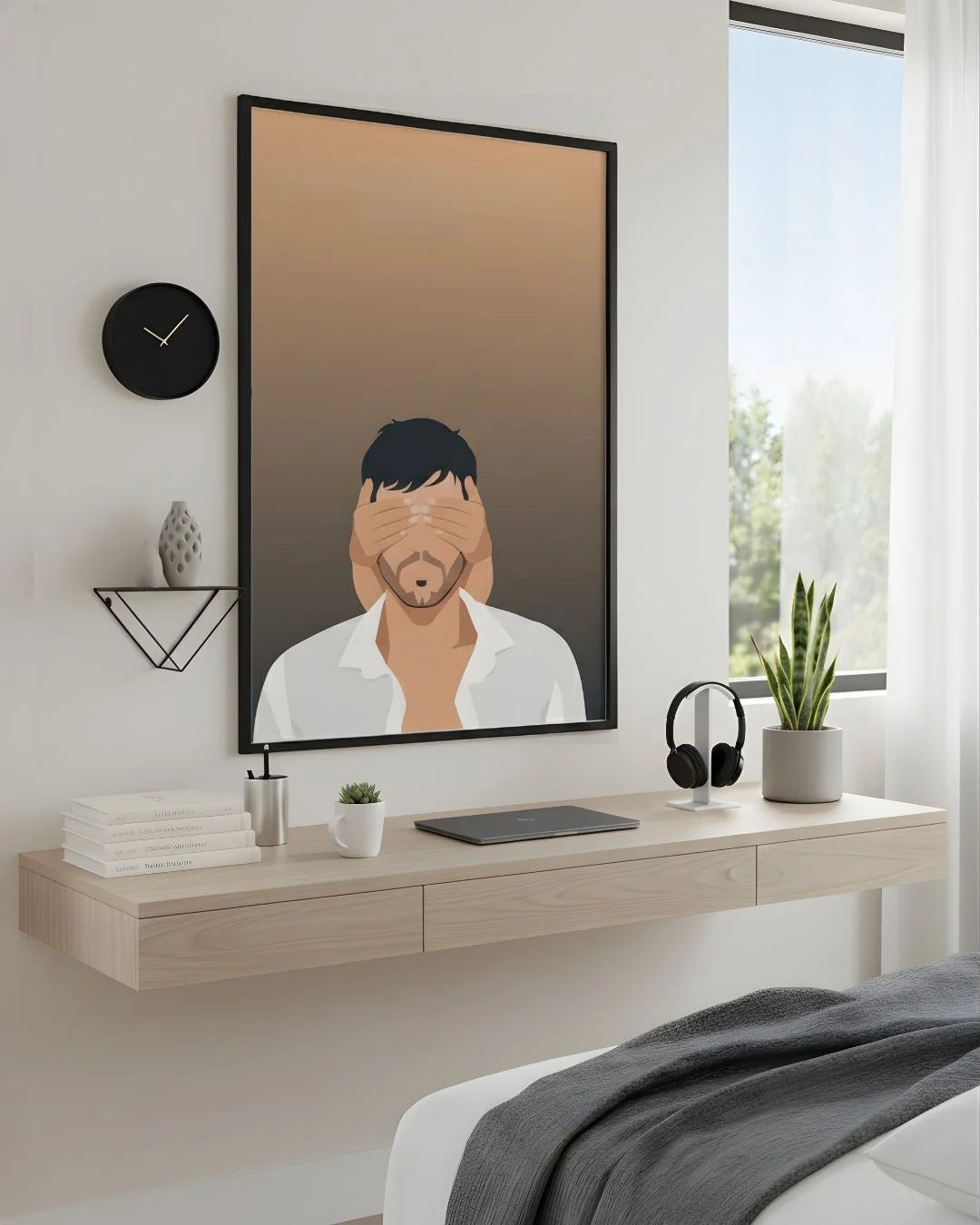 Minimalist Enrique Iglesias "Love and Sex" print in an XL Noir Black frame (24x36in) styled above a light wood floating desk in a modern bedroom-office.