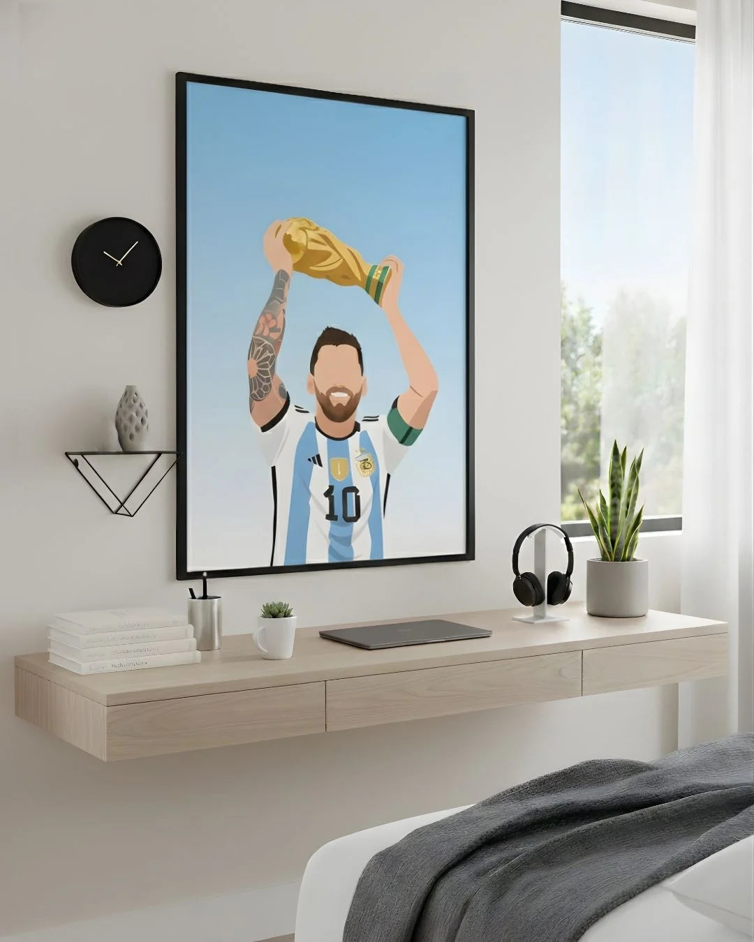 Minimalist Lionel Messi Argentina World Cup art in an XL Noir Black frame (24x36in) styled above a light wood floating desk.