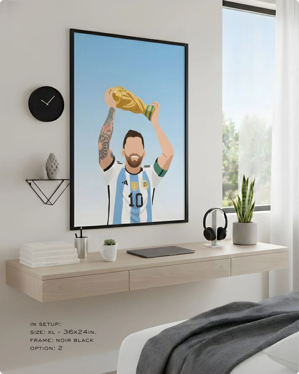 Minimalist Lionel Messi Argentina World Cup art in an XL Noir Black frame (24x36in) styled above a light wood floating desk.