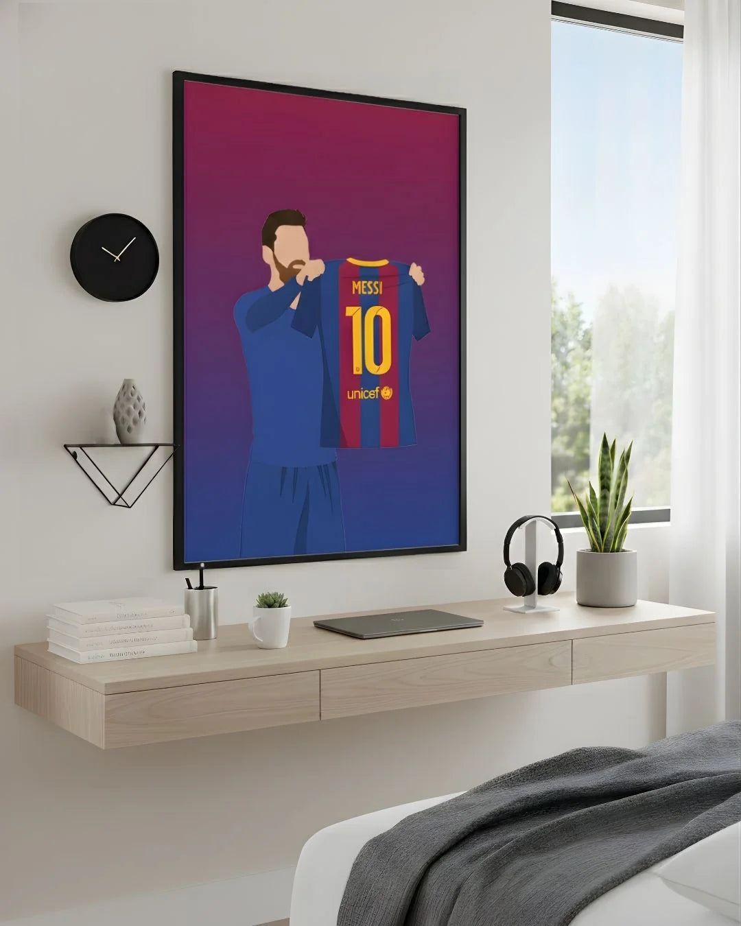 Minimalist Lionel Messi Barcelona celebration print in an XL Noir Black frame (24x36in) styled above a light wood floating desk in a modern bedroom-office.