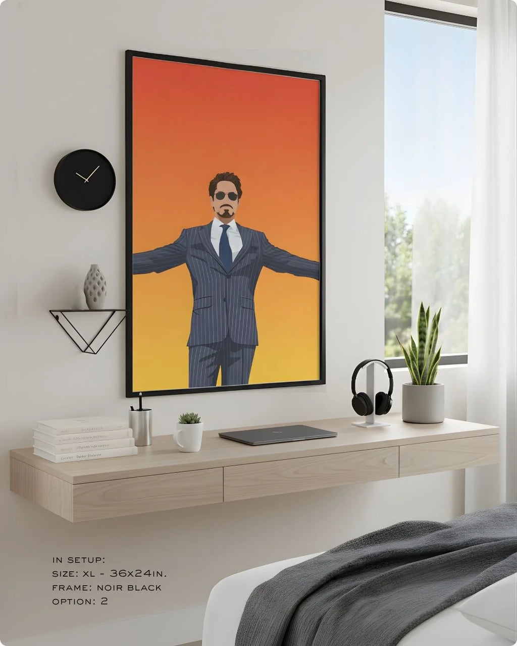 Minimalist Tony Stark (Iron Man) print in an XL Noir Black frame (24x36in) styled above a light wood floating desk in a modern bedroom-office.