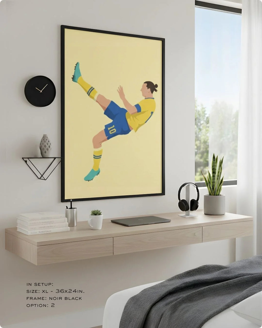 Minimalist Zlatan Ibrahimović bicycle kick print in an XL Noir Black frame (24x36in) styled above a floating desk in a modern bedroom-office.