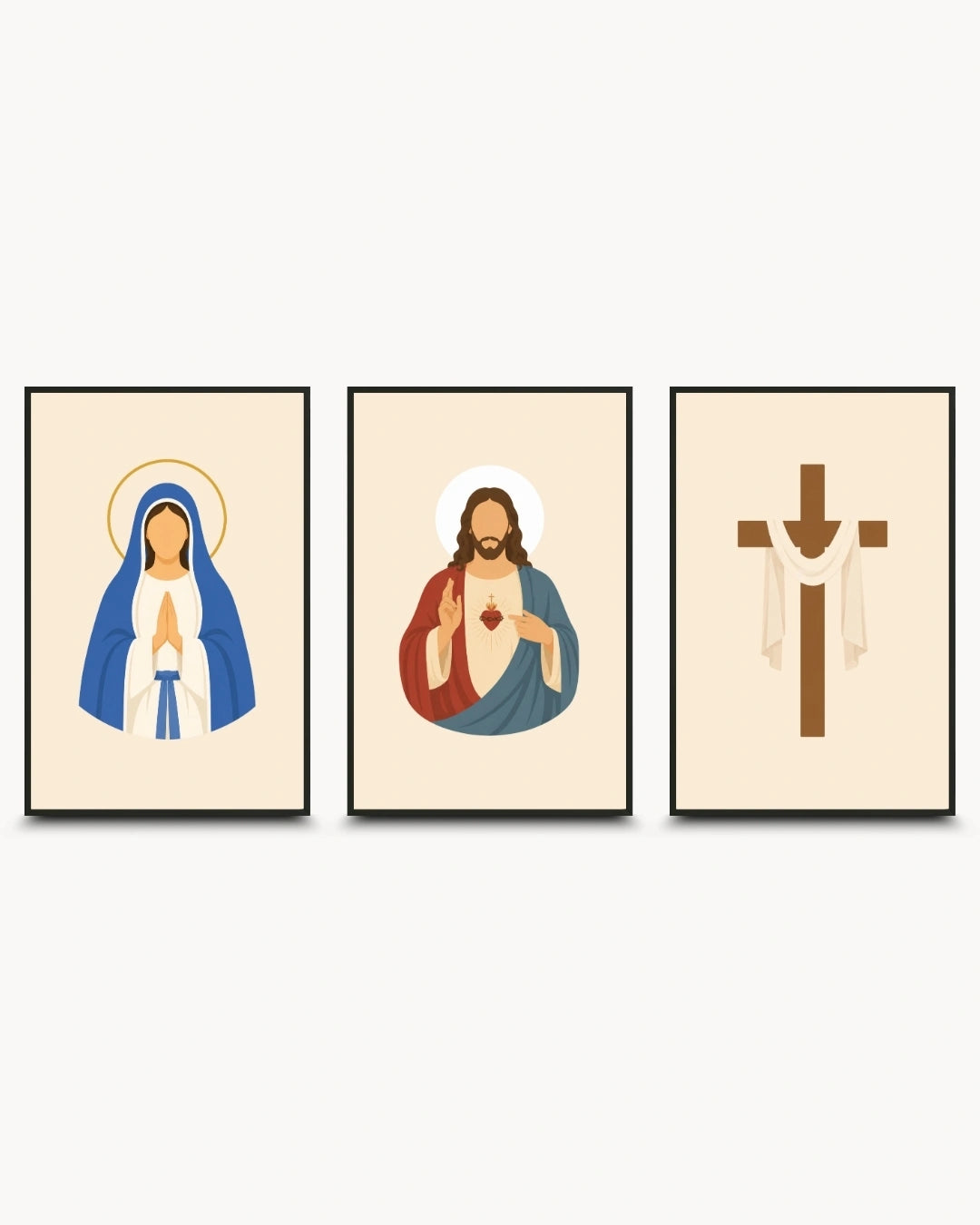 Three framed religious wall art prints shown side by side on a light gray background. The left print shows the Virgin Mary in blue and white with a gold halo, the center print shows Jesus with a red and blue robe and a white halo, and the right print shows a brown Christian cross with white drapery.