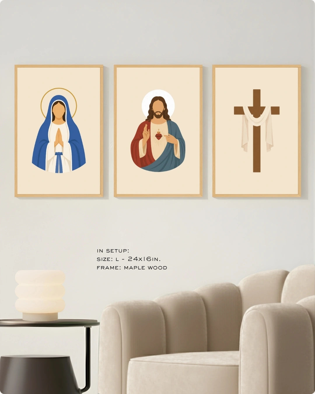 Three framed religious wall art prints displayed above a sofa in a living room setting. The left print shows the Virgin Mary in blue and white with a gold halo, the center print shows Jesus with red and blue robes and a glowing heart, and the right print shows a brown Christian cross with white drapery.