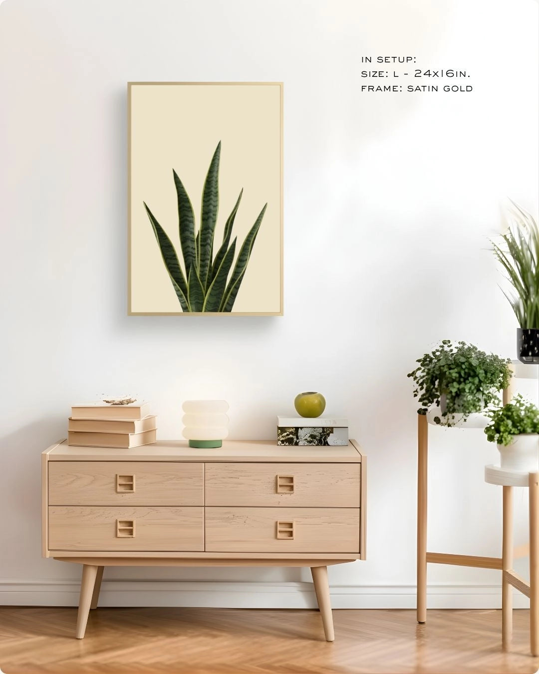 K2C Co. snake plant art in an elegant Satin Gold frame, displayed on a light wood sideboard with a mushroom lamp and indoor greenery.