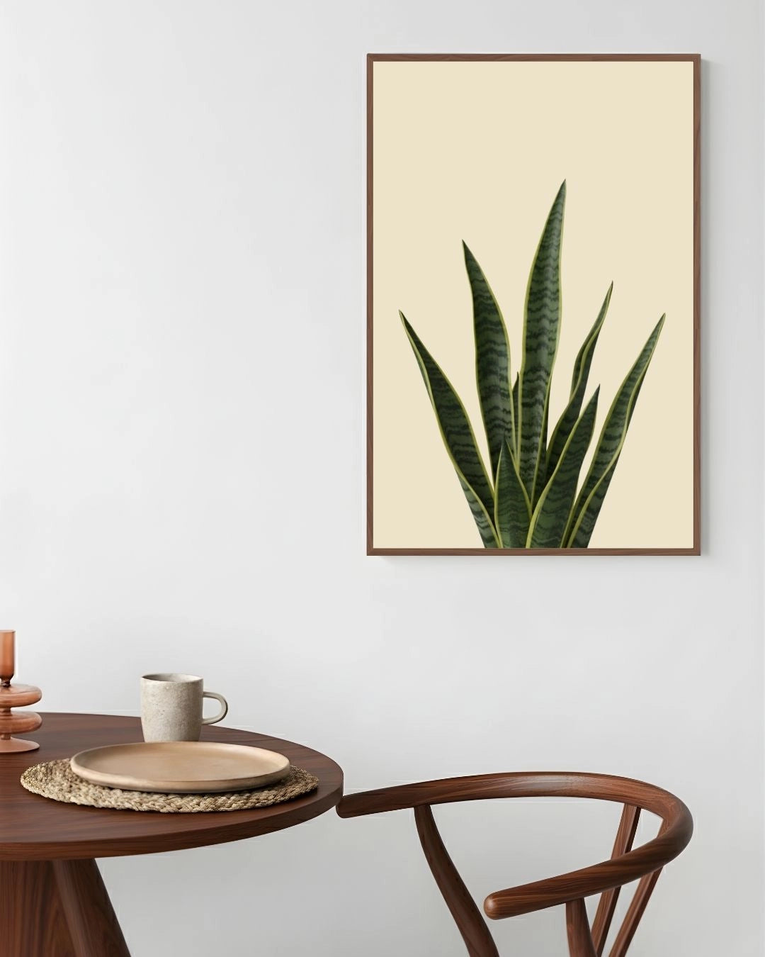 Framed plant poster on a wall above a wooden table with a chair.