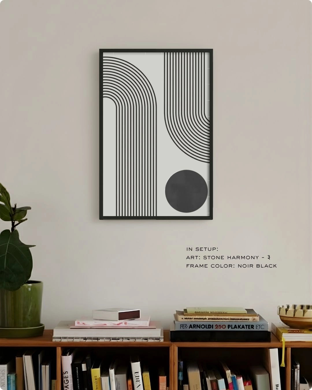 Stone Harmony 3 abstract wall art by K2C Co. featuring a charcoal grey circle and black curved lines in a Noir Black frame, displayed in a minimalist living room mockup above a wooden bookshelf.