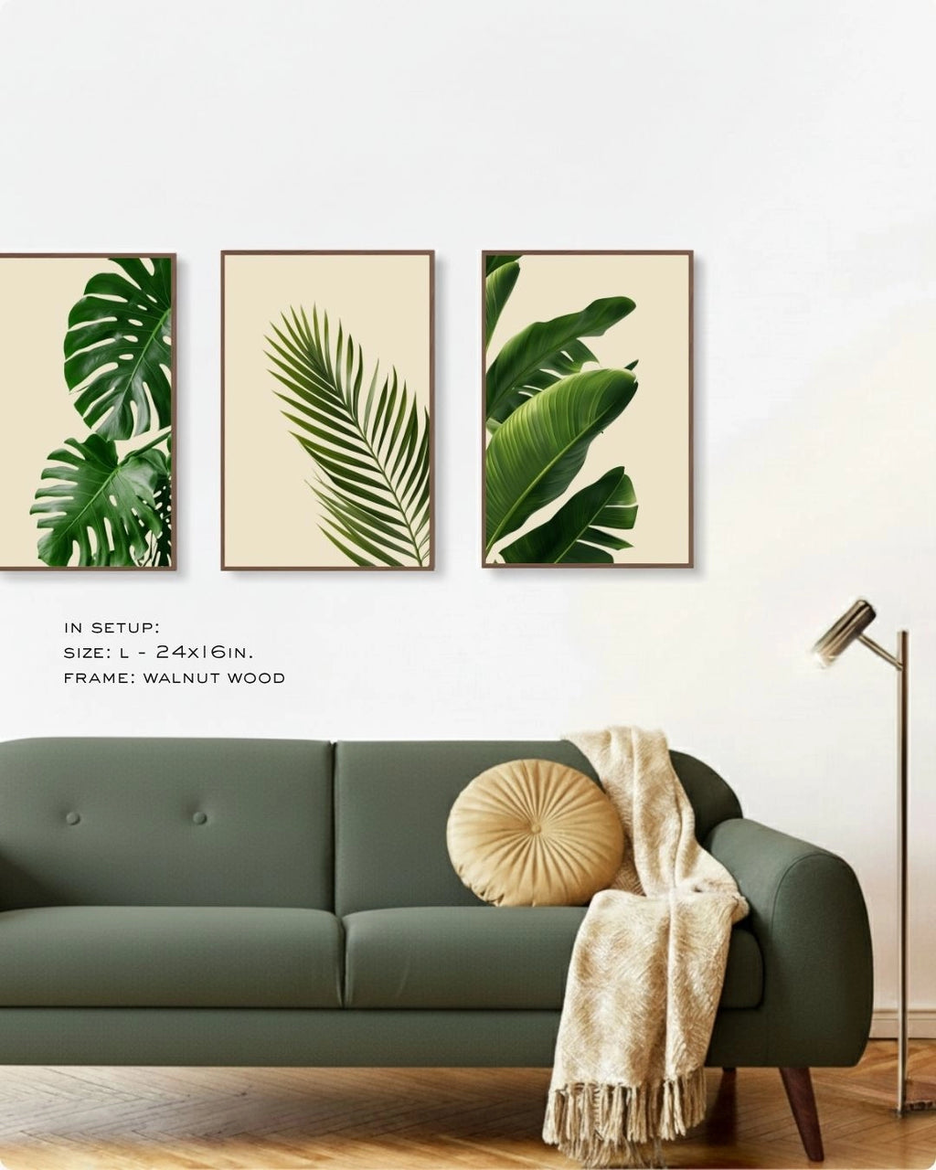 Minimalist 3-piece tropical leaf gallery wall by K2C Co. in Walnut Wood frames, displayed above a green sofa with a round cushion and throw blanket.