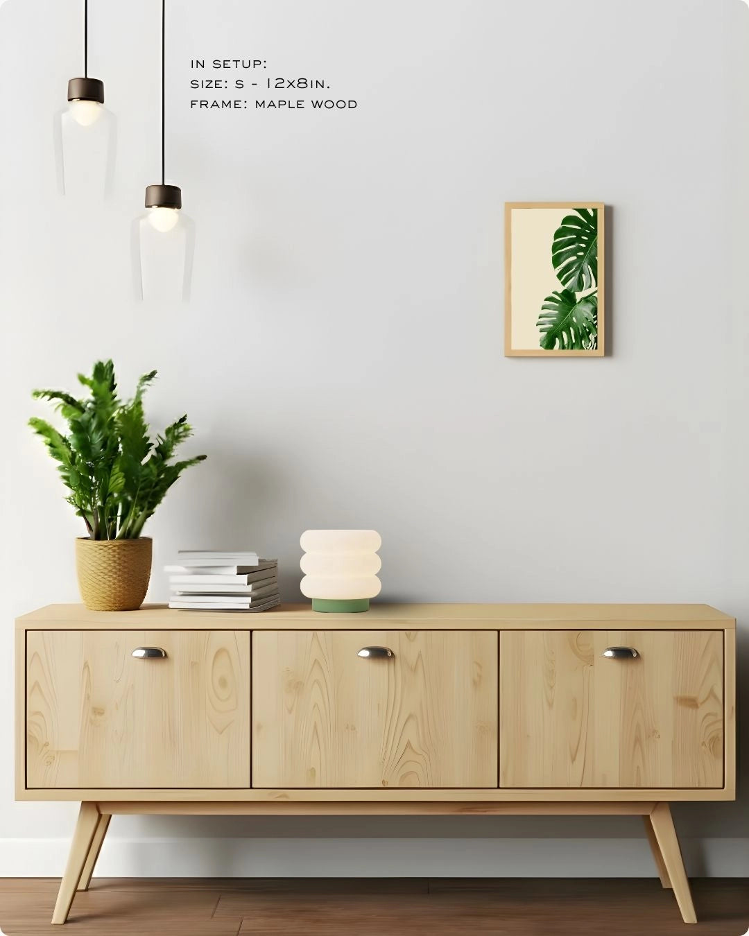 Small accent banana leaf wall art in a Maple Wood frame by K2C Co., featured in a minimalist Japandi living room decor mockup to show scale.