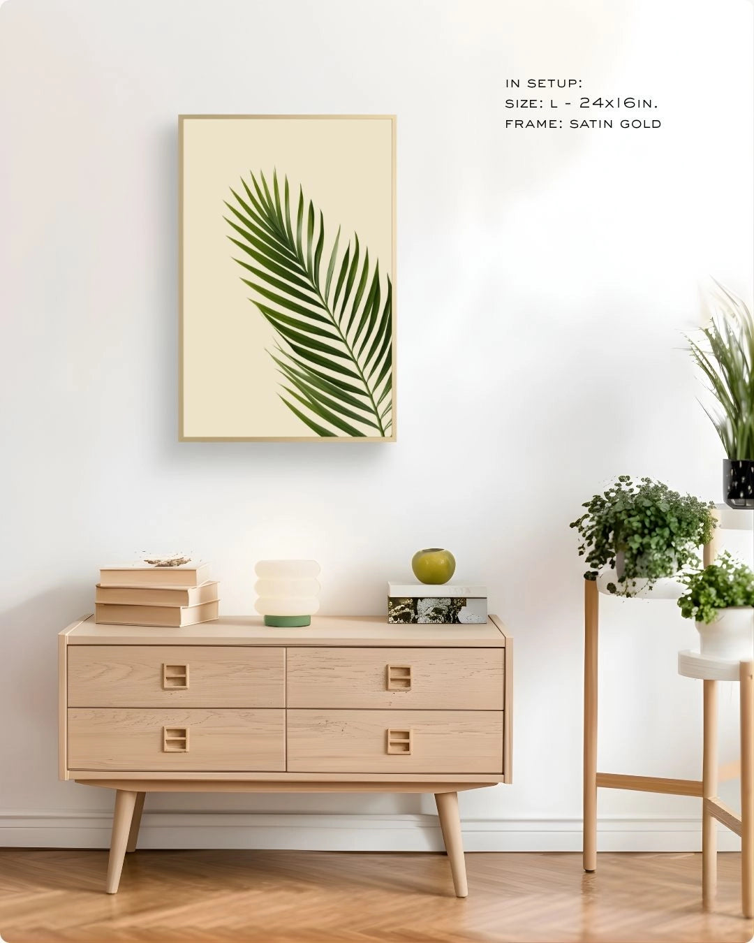 K2C Co. tropical palm leaf print in an elegant Satin Gold frame, styled on a neutral dresser with a mushroom lamp and indoor plants for a minimalist bedroom or office.