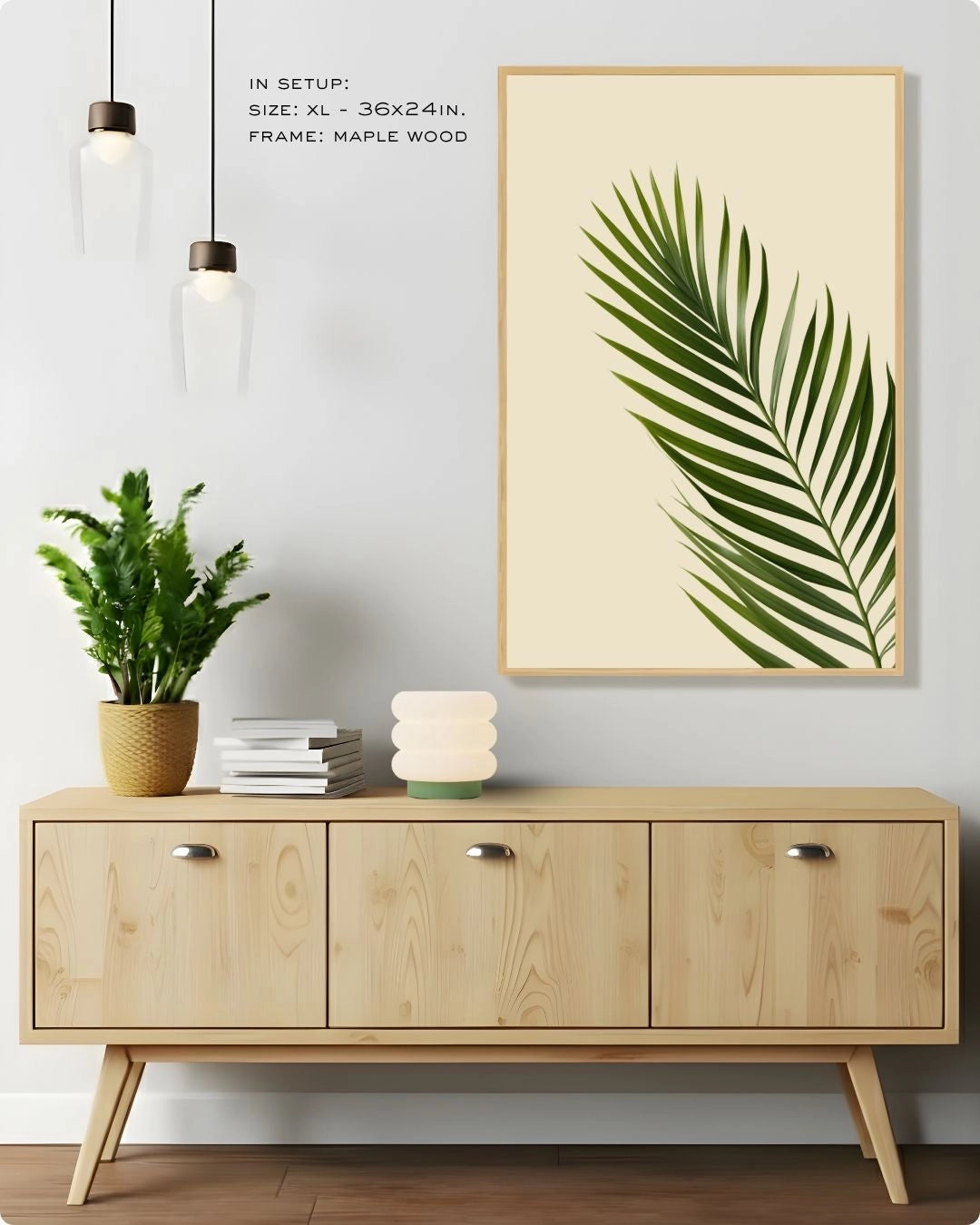 Large-scale (Size XL) tropical palm leaf botanical art by K2C Co. in a Maple Wood frame, hanging above a light wood sideboard with modern pendant lighting.