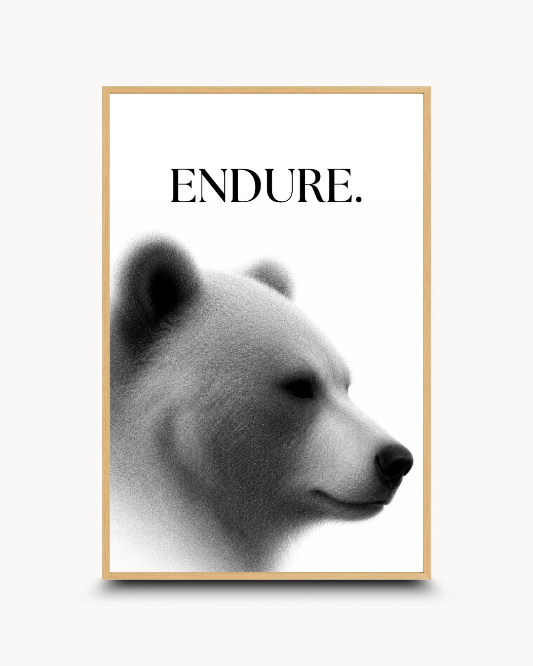 A framed art print featuring a black and white polar bear profile with the word 'ENDURE.' printed above it, set in a light wood frame against a light gray background.
