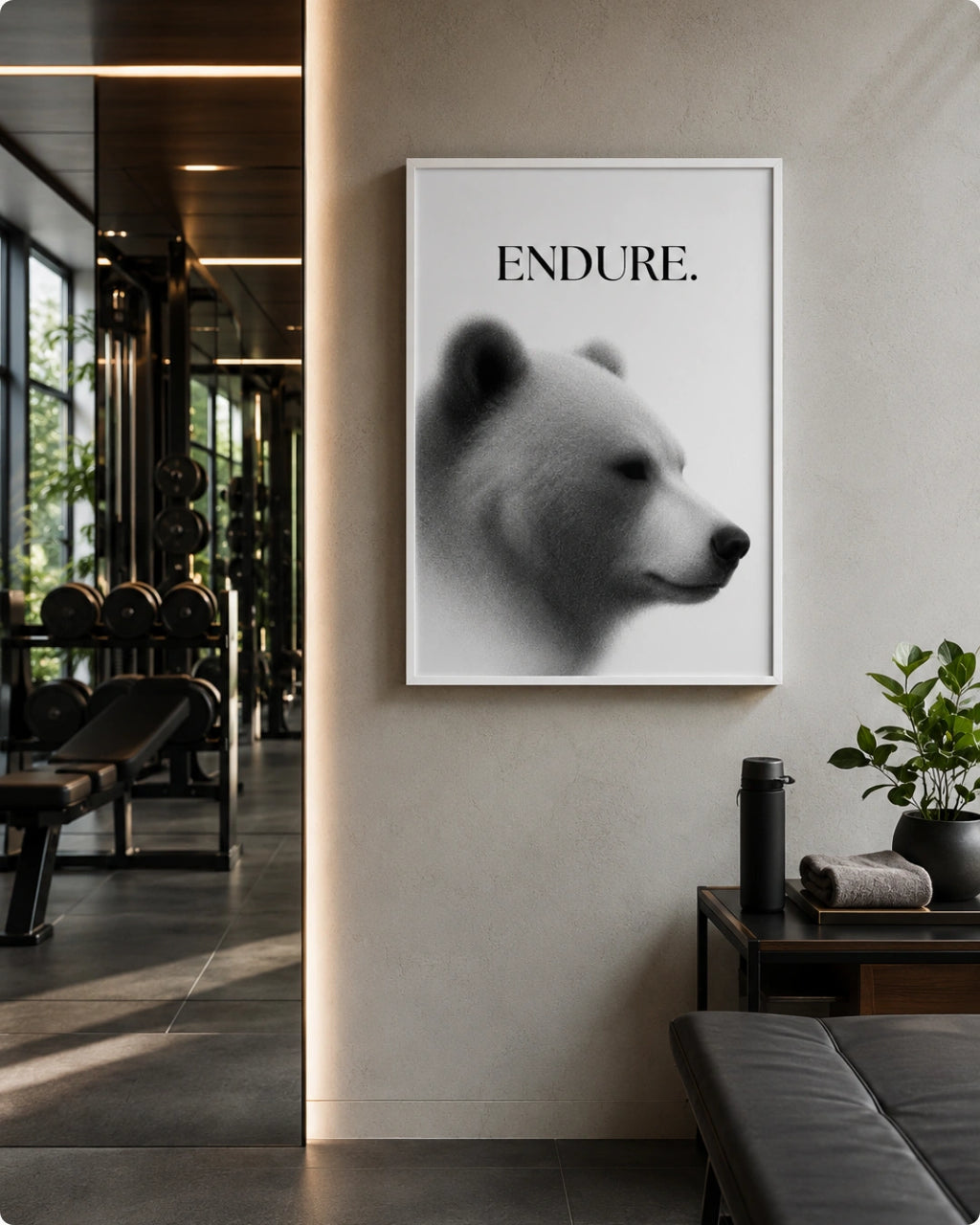 A framed black and white art print featuring a polar bear profile with the word 'ENDURE.' above it, displayed on a beige wall in a modern interior setting.