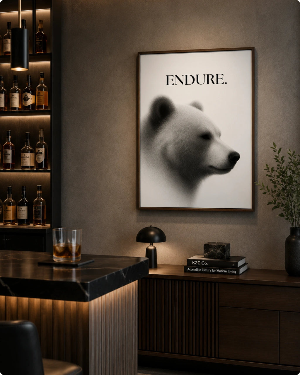 A framed wall art print featuring a black-and-white polar bear portrait with the word 'ENDURE.' at the top, displayed in a modern bar or lounge setting above a counter.