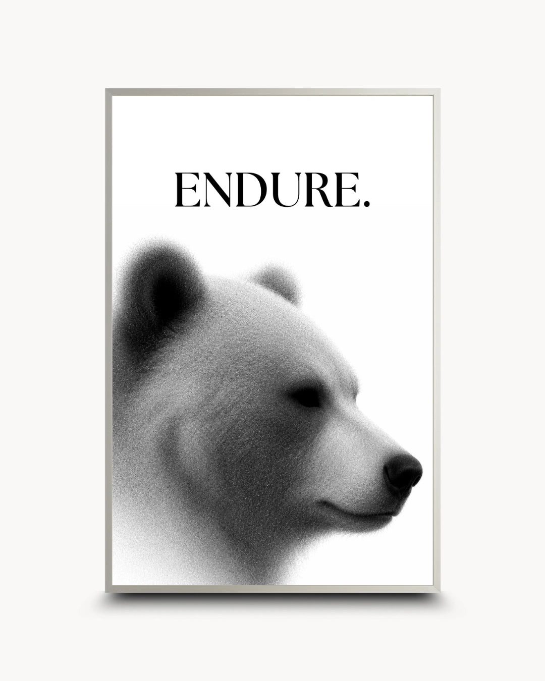 A framed black and white art print featuring a polar bear profile with the word 'ENDURE.' above it, shown against a light neutral background.