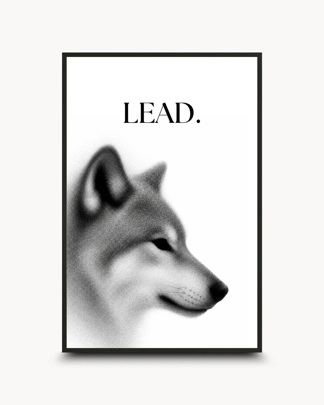 A framed black and white art print featuring a stylized dog head profile with the word 'LEAD.' above it, shown against a light neutral background.