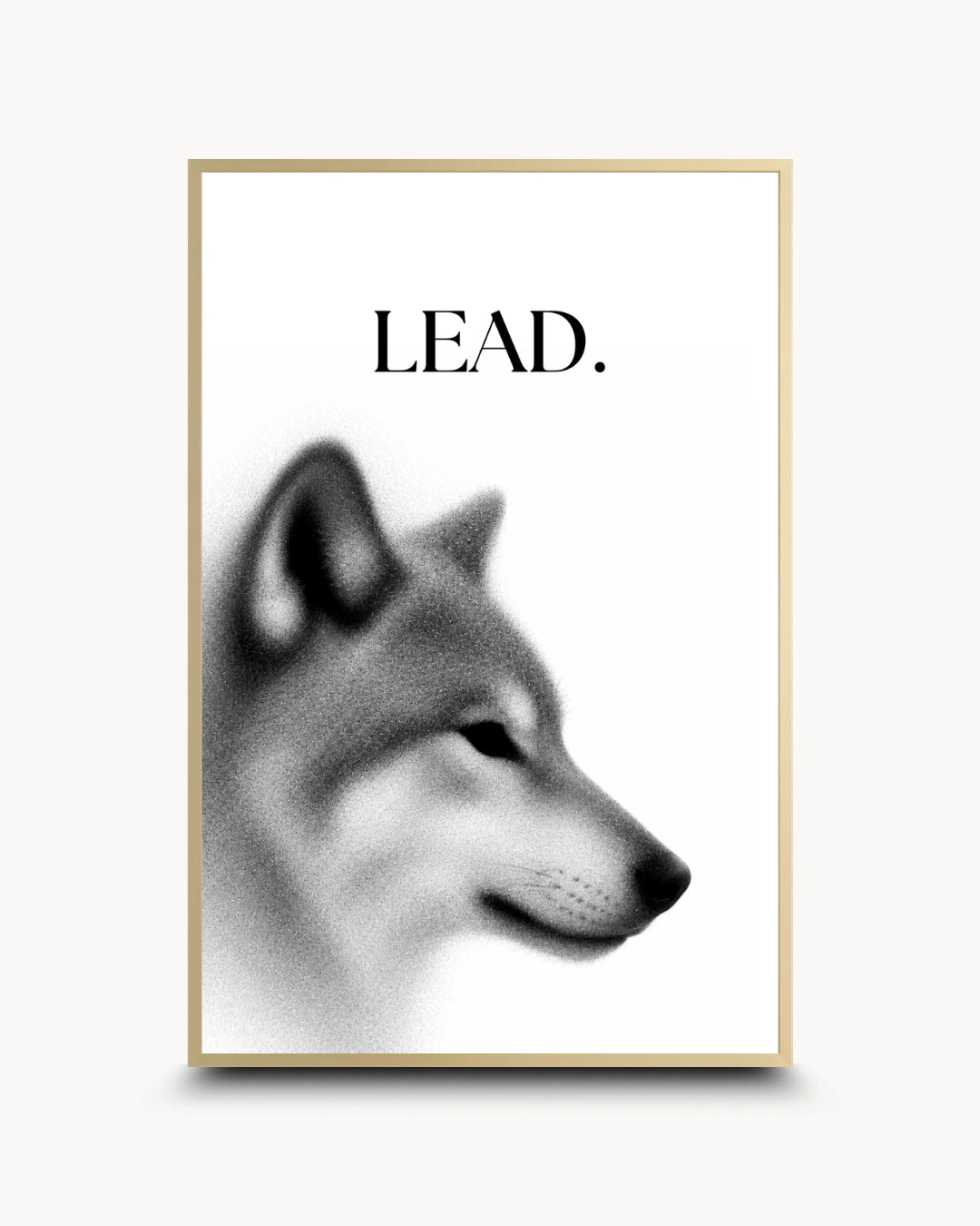 A framed wall art print featuring a grayscale wolf head profile with the word 'LEAD.' above it, shown against a light neutral background.