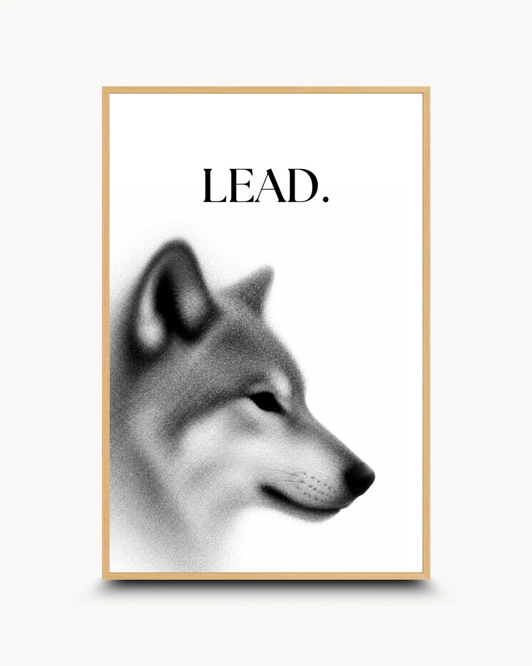 A framed art print featuring a black and white profile illustration of a wolf or dog with the word 'LEAD.' printed above it, shown against a light neutral background.