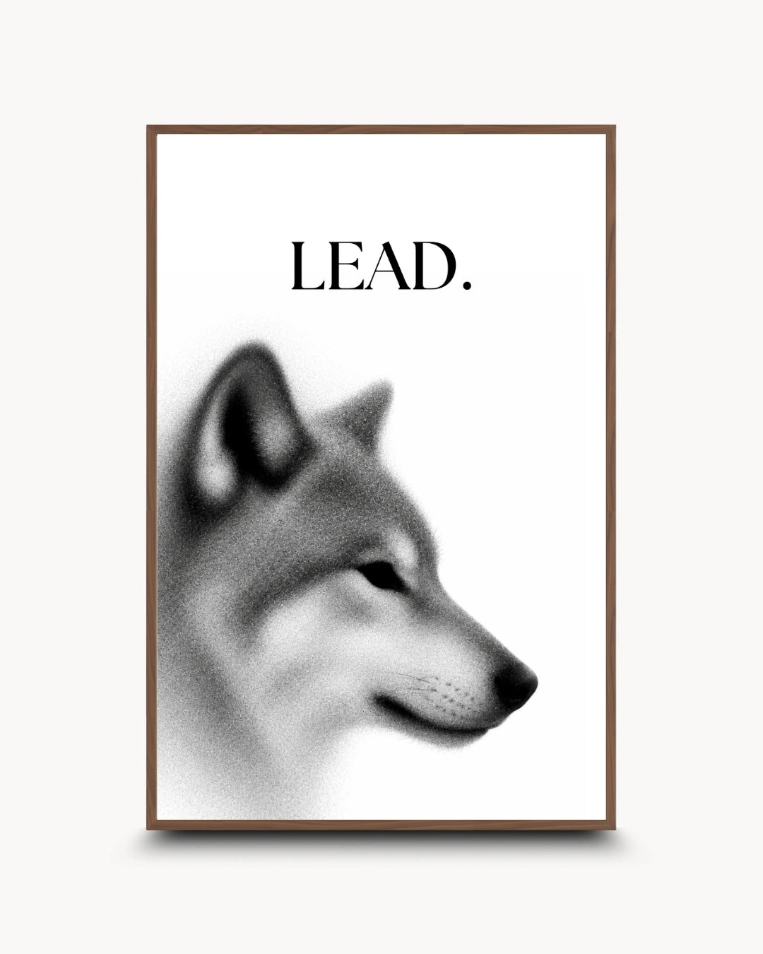 A framed wall art print featuring a grayscale dog head illustration with the word "LEAD." above it, shown against a light neutral background.