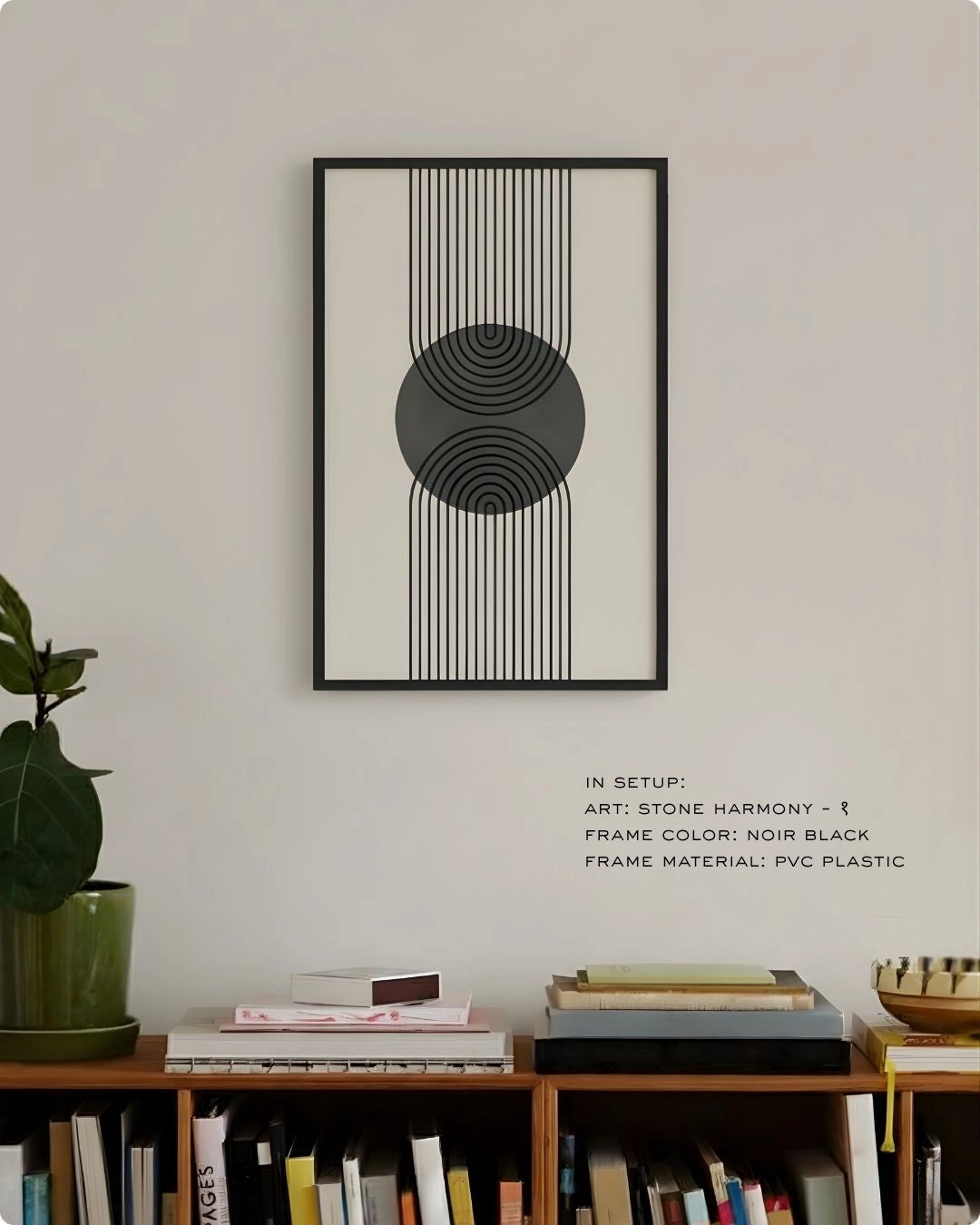 Stone Harmony 1 abstract wall art by K2C Co. featuring a charcoal grey circle and black geometric lines in a Noir Black frame, displayed in a minimalist living room mockup above a wooden bookshelf.